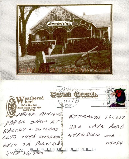 Stone Building with Weathered Wheel Sign