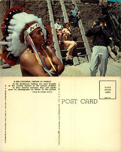 Indigenous man and tourists at a Pueblo