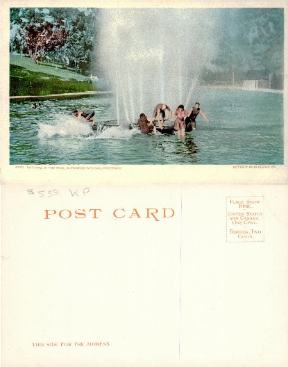 People bathing in a large pool with fountain