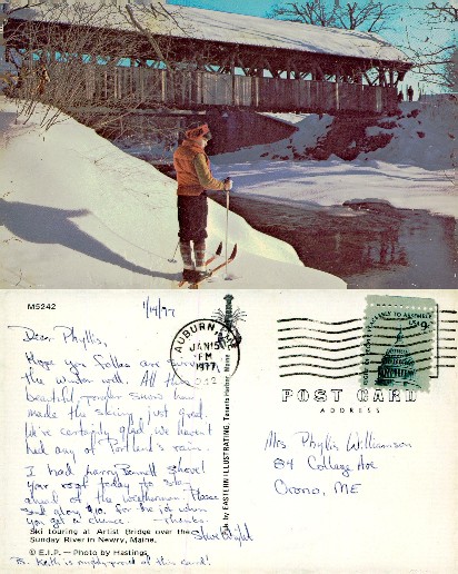 Skier at snow-covered covered bridge