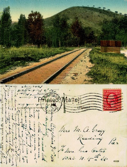 Rural Railroad Tracks and Green Hill