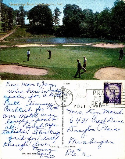 Golfers on a golf course with pond