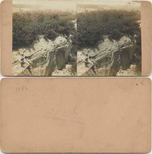 People Seated on a High Rock Ledge