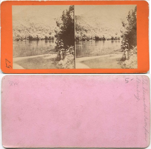 River with forested hills and man