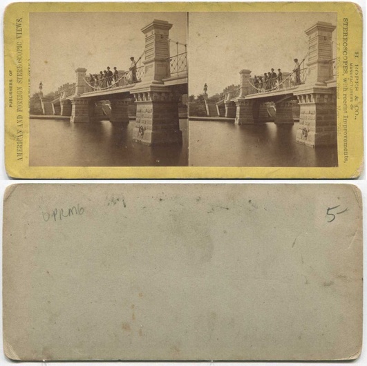 Stone bridge with people over water