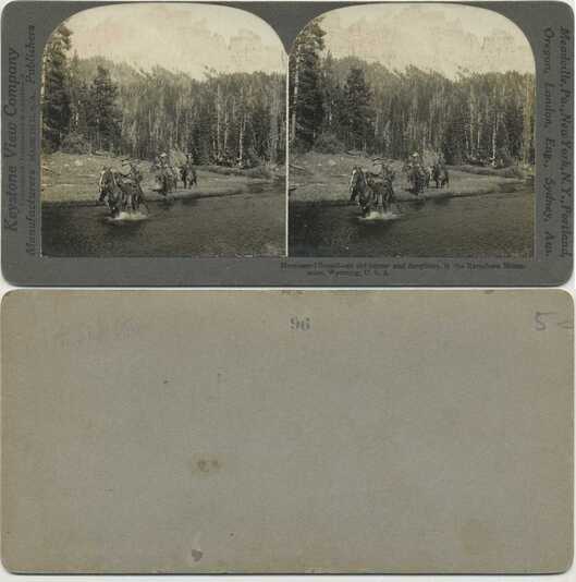 Horsemen fording river in mountains