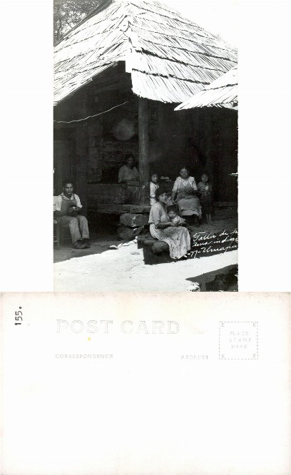 Indigenous Family by Thatched Hut